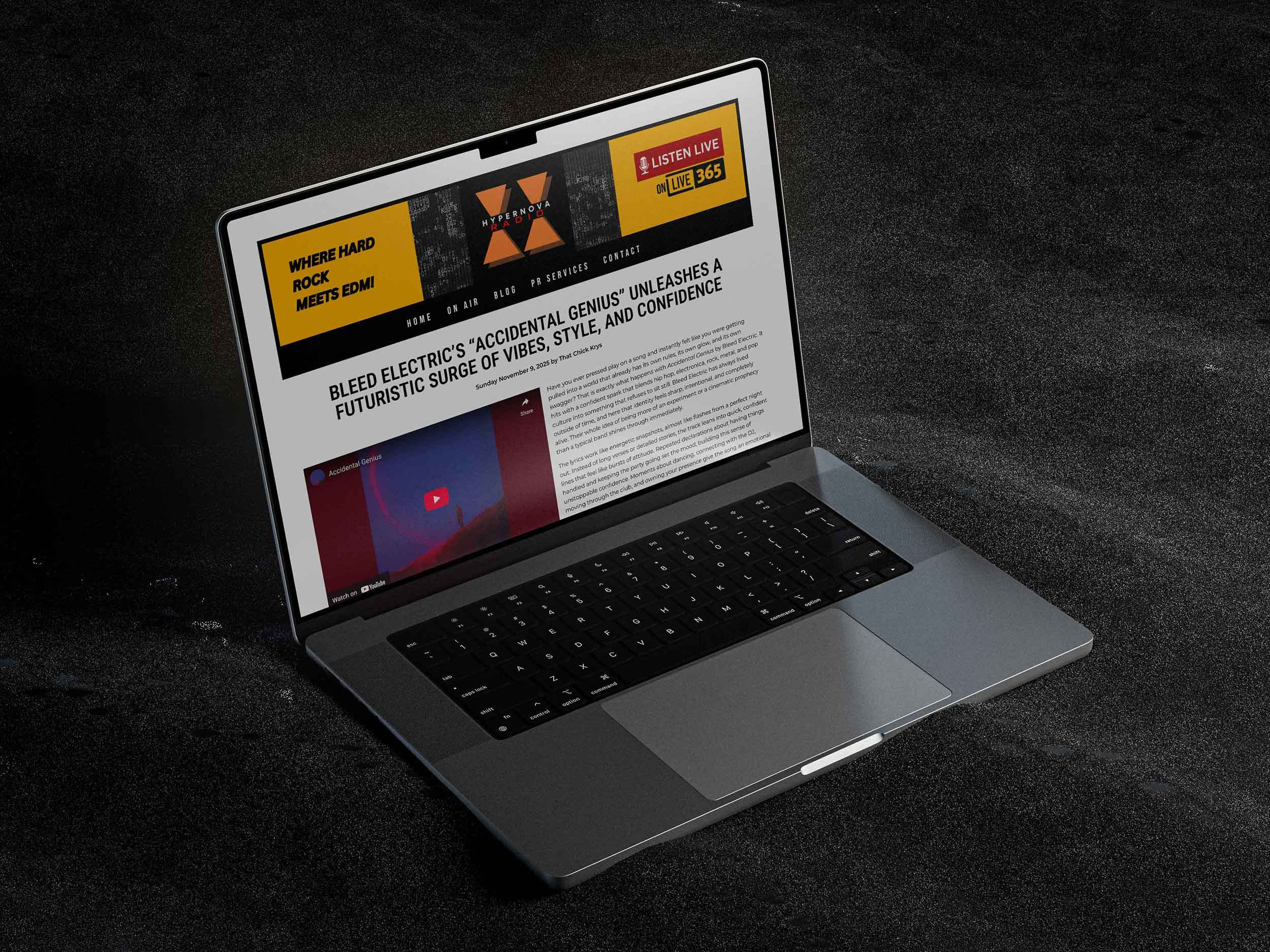 Laptop displaying the Hypernova Radio premiere of a Bleed Electric track, surrounded by neon sci-fi lighting and futuristic cables.